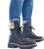 A pair of black Rieker women's lace-up boots with fur trim, worn with blue jeans. Anteprima dell’immagine prodotto