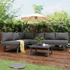 An outdoor patio scene with a sectional sofa, coffee table, and umbrella. Produktbild-Vorschau