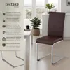 A dining chair next to a table in a bright, modern room. Produktbild-Vorschau