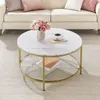 A coffee table with a marble top and gold legs is placed in a living room setting with a sofa and pillows. Náhled obrázku produktu