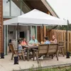 A family is having a meal under a white pop-up canopy on a patio. Produktbild-Vorschau