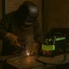 A person is welding metal with a welding machine. Produktbild-Vorschau