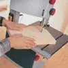 A person is using a bandsaw to cut a piece of wood. Anteprima dell’immagine prodotto
