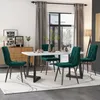 A dining room scene with a table and chairs, set up for a meal.