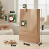 A brown paper gift bag with Christmas-themed stickers and clothespins on a wooden surface. Produktbild-Vorschau