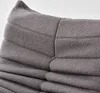A close-up view of the textured fabric of a gray sofa or chair. Náhled obrázku produktu