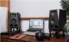 A desk setup with audio equipment, including studio monitors, a laptop, and headphones. Náhľad obrázku produktu