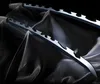 Two swords with jagged blades are displayed on black fabric. Podgląd zdjęcia produktu