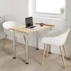 A small dining table with two chairs in a bright room, near a window. Produktbild-Vorschau