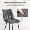 A close-up of a dark gray upholstered chair with text overlays and diagrams highlighting its features. Produktbild-Vorschau