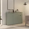 A sage green sideboard with three doors and one drawer, decorated with vases and books, in a room with a framed picture on the wall and a lamp. Anteprima dell’immagine prodotto