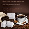Coffee filters, coffee beans, and a cup of coffee are arranged on a brown background. Produktbild-Vorschau
