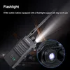 A black walkie-talkie with its flashlight on, set against a dark background with construction equipment. Anteprima dell’immagine prodotto