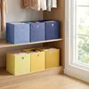 Storage boxes on shelves in a closet. Produktbild-Vorschau