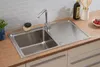 A stainless steel kitchen sink with a faucet and a draining board, set on a wooden countertop with a tiled backsplash. Produktbild-Vorschau
