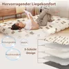 A woman is lying on a mattress with a bear pattern, reading a book. The image also shows a layered diagram of the mattress. Náhled obrázku produktu