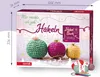 A close-up view of an advent calendar box with crochet ornaments and yarn. Produktbild-Vorschau