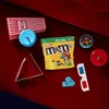 A collection of movie-watching snacks and accessories laid out on a red surface. Náhľad obrázku produktu