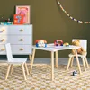 A child's play area with a dresser, a small table and chairs, and toys. Anteprima dell’immagine prodotto