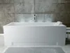 A modern white bathtub in a bathroom with a tiled wall. Produktbild-Vorschau