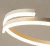 A close-up shot of a modern LED pendant light with curved, layered elements. Produktbild-Vorschau