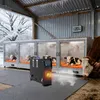 Calves in heated enclosures inside a barn during winter, with a heater unit in the foreground. Voir les images du produit