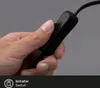 A hand is shown pressing a black switch on a black cable. Produktbild-Vorschau