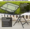A close-up of a glass-top side table with a black metal frame, set outdoors on a patio with grass and a white fence in the background. Text overlays highlight product features. Produktbild-Vorschau
