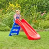 A young child is playing on a red and blue slide in a garden. Anteprima dell’immagine prodotto