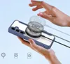 A hand is shown holding a smartphone with a blue case, and a magnetic charger is attached to the back of the phone. The charger is depicted with motion blur, suggesting it is in use or being attached. Voir les images du produit
