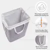 A grey fabric laundry basket with white handles and trim, shown from the inside with annotations highlighting its features. Produktbild-Vorschau