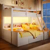 A bunk bed with a lower bed and storage drawers, illuminated by warm LED lights, in a bedroom setting with decorative items and a window view. Produktbild-Vorschau