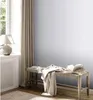 A room interior with a window, curtains, a bench with a book and a blanket, and a lamp. Podgląd zdjęcia produktu
