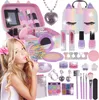 A young girl is applying lipstick from a makeup set that includes a unicorn-themed handbag, nail polish, eyeshadow, and various accessories. Voir les images du produit