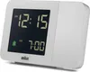 A white digital alarm clock with a black screen displaying the time and alarm settings. Produktbild-Vorschau