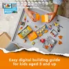 A child's hands are building a LEGO stunt park set on a gray play mat. The set includes a motorcycle, a spider-like vehicle, and various building pieces. Podgląd zdjęcia produktu
