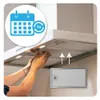 A person is shown removing a filter from a range hood, with an overlay graphic indicating a calendar and '3x' with circular arrows. Produktbild-Vorschau