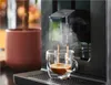 A close-up shot of an espresso machine dispensing coffee into a clear glass cup, with steam rising. Voir les images du produit