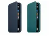 Two iPhone cases, one dark blue and one teal, are shown side-by-side against a white background. Produktbild-Vorschau