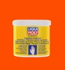 A yellow tub of Liqui Moly hand protection cream against an orange background. Produktbild-Vorschau