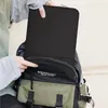 A person is putting a black laptop sleeve into a backpack. Produktbild-Vorschau