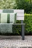 A garden bench with cushions and a throw in a garden setting. Produktbild-Vorschau
