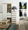 A modern living room scene with a dresser, coffee table, and sofa, decorated with artwork and flowers. Produktbild-Vorschau
