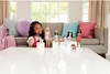 A young girl is playing with Barbie dolls and their dogs in a living room setting. Podgląd zdjęcia produktu