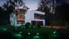 A modern house at dusk with green LED lights illuminating the lawn and pathway. Produktbild-Vorschau