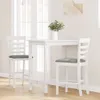A white bar table and two white bar stools with gray cushions are shown in a room with natural light coming from a window. Náhled obrázku produktu
