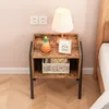 A bedside table with a lamp, a stacking toy, and a framed picture of a sloth. Podgląd zdjęcia produktu
