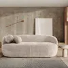 A modern living room setting with a sofa and decorative elements. Produktbild-Vorschau