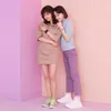 Two young women posing together against a pink and purple background, both wearing watches. Anteprima dell’immagine prodotto