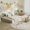 A child's bedroom with a floor bed, decorated with a mountain mural and playful accessories. Anteprima dell’immagine prodotto